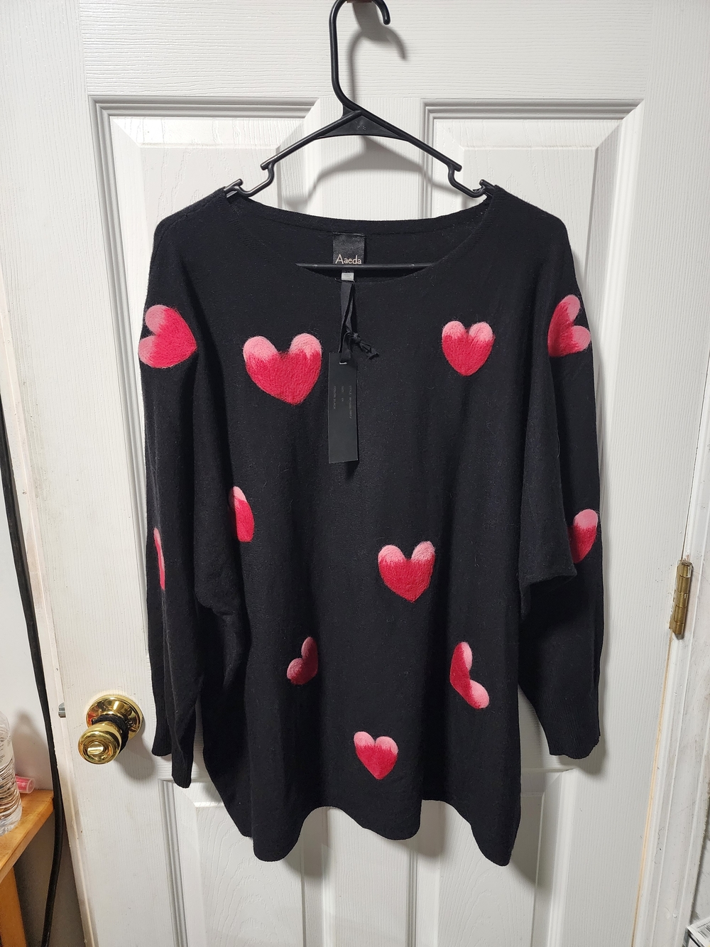 AVEDA Black Sweater with Pink Heart Motifs